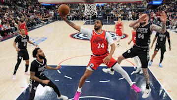 Apr 8, 2025; Inglewood, California, USA; LA Clippers guard Norman Powell (24) shoots the ball against San Antonio Spurs forward Julian Champagnie (30) and forward Sandro Mamukelashvili (54) in the first half at Intuit Dome. Mandatory Credit: Kirby Lee-Imagn Images