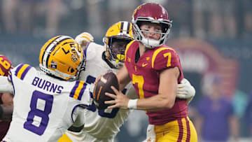Sep 1, 2024; Paradise, Nevada, USA; Southern California Trojans quarterback Miller Moss (7) is pressured by LSU Tigers safety Major Burns (8) and tight end Gabe Leonards (85) in the first half at Allegiant Stadium. Mandatory Credit: Kirby Lee-USA TODAY Sports