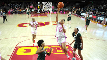 Feb 19, 2025; Los Angeles, California, USA; Southern California Trojans guard JuJu Watkins (12) shoots the ball against Michigan State Spartans guard Nyla Hampton (22) and guard Jocelyn Tate (11) in the second half at the Galen Center.
