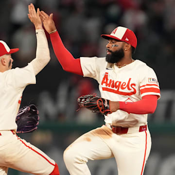Jun 7, 2025; Anaheim, California, USA; Los Angeles Angels shortstop Zach Neto (9) and center fielder Jo Adell (7) celebrate at the end of the game against the Seattle Mariners at Angel Stadium. Mandatory Credit: Kirby Lee-Imagn Images
