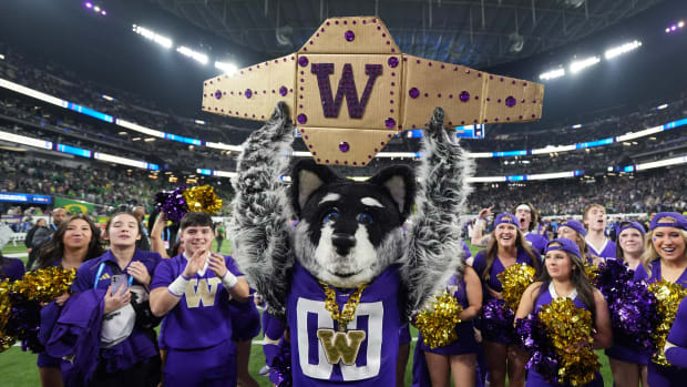 Washington Huskies mascot Harry the Husky and cheerleaders pose after the Pac-12 Championship game against the Oregon Ducks a