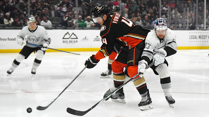 Apr 13, 2024; Los Angeles, California, USA; Anaheim Ducks defenseman Cam Fowler (4) and LA Kings right wing Viktor Arvidsson (33) battle for the puck in the second period at Crypto.com Arena. Mandatory Credit: Kirby Lee-Imagn Images