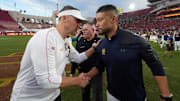 Trojans coach Lincoln Riley and Irish coach Marcus Freeman shake hands after the 2024 game.