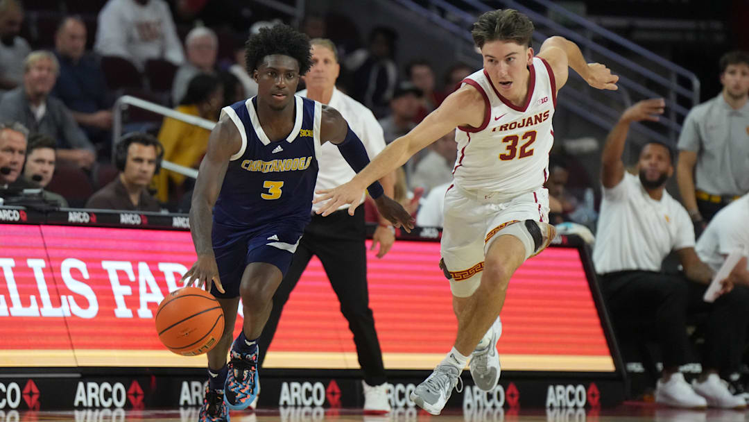 Nov 4, 2024; Los Angeles, California, USA; Chattanooga Mocs guard Honor Huff (3) dribbles the ball against Southern California Trojans guard Clark Slajchert (32) in the second half at Galen Center. Mandatory Credit: Kirby Lee-Imagn Images