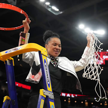 Apr 7, 2024; Cleveland, OH, USA; South Carolina Gamecocks head coach Dawn Staley cuts down the net after the 2024 NCAA Tournament Women's Final Four championship game against the Iowa Hawkeyes at Rocket Mortgage FieldHouse.  Mandatory Credit: Kirby Lee-Imagn Images