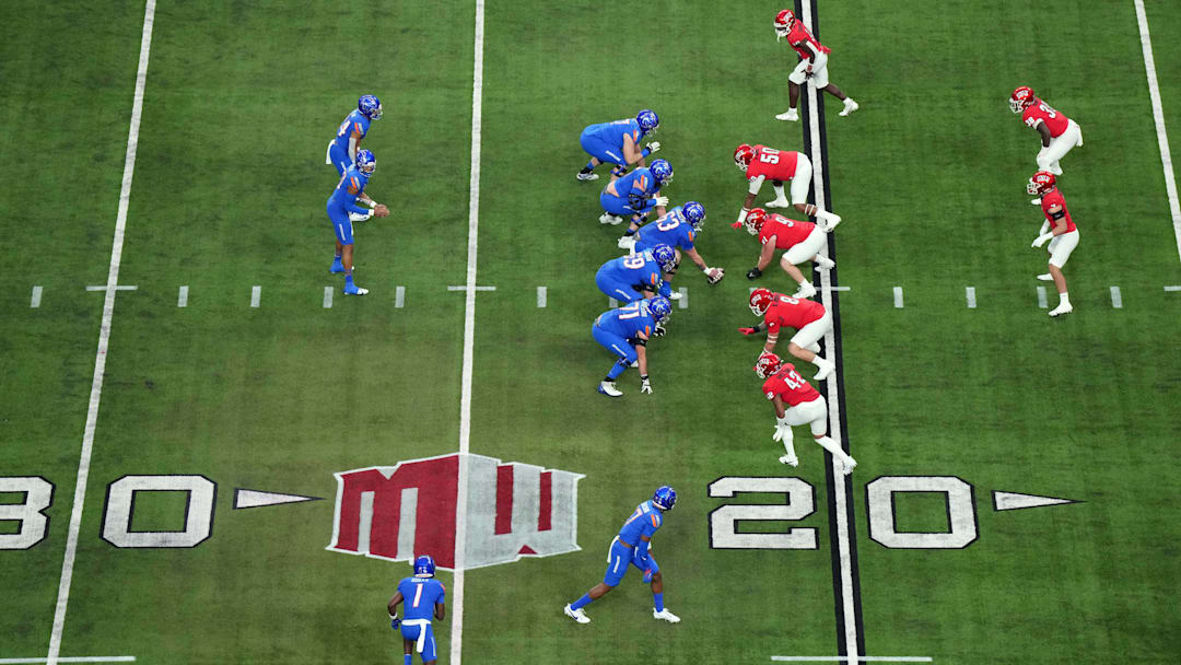 A general overall view as Boise State Broncos quarterback Taylen Green (10) prepares to take the snap against the UNLV Rebels on the Mountain West conference logo in the first half during the Mountain West Championship at Allegiant Stadium. Mandatory Credit: Kirby Lee-Imagn Images
