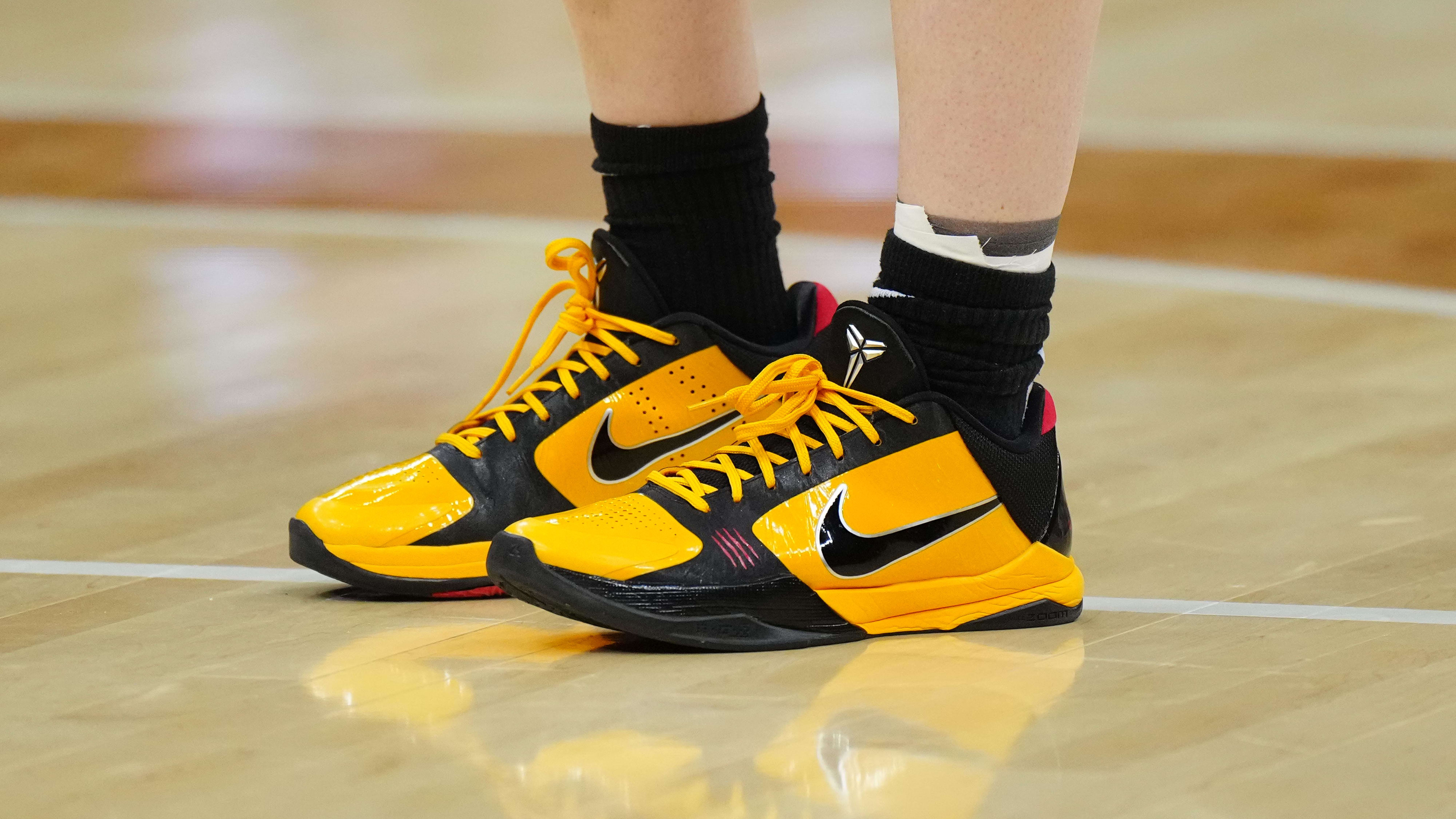 Iowa Hawkeyes guard Caitlin Clark's black and gold Nike Kobe sneakers.