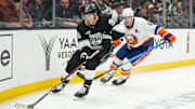 Mar 11, 2025; Los Angeles, California, USA; LA Kings left wing  Andrei Kuzmenko (96) skates against New York Islanders defenseman Ryan Pulock (6) in the second period at the Crypto.com Arena. Mandatory Credit: Kirby Lee-Imagn Images