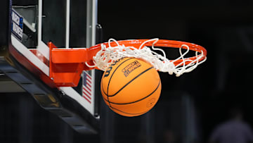 Mar 19, 2025; Wichita, KS, USA; A Wilson official NCAA Evo NXT basketball with the March Madness logo approaches the rim and the net at Intrust Bank Arena.