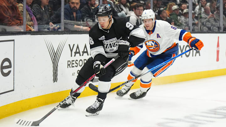 Mar 11, 2025; Los Angeles, California, USA; LA Kings left wing  Andrei Kuzmenko (96) skates against New York Islanders defenseman Ryan Pulock (6) in the second period at the Crypto.com Arena. Mandatory Credit: Kirby Lee-Imagn Images