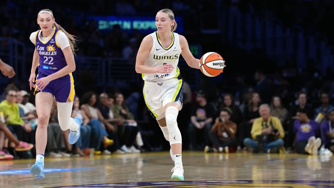 Aug 20, 2025; Los Angeles, California, USA; Dallas Wings guard Paige Bueckers (5) dribbles the ball against LA Sparks forward Cameron Brink (22) in the first half at Crypto.com Arena. Mandatory Credit: Kirby Lee-Imagn Images