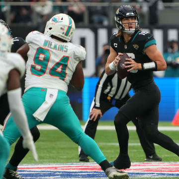Jacksonville Jaguars quarterback Trevor Lawrence (16) throws the ball against the Miami Dolphins during an NFL International Series game at Tottenham Hotspur Stadium in 2021.