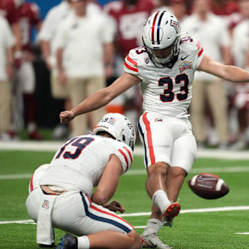 Dec 28, 2023; San Antonio, TX, USA; Aizona Wildcats place kicker Tyler Loop (33) kicks a 37-yard field goal out of the hold of punter Kyle Ostendorp (19) in the second half of the Alamo Bowl against the Oklahoma Sooners at Alamodome. Mandatory Credit: Kirby Lee-Imagn Images