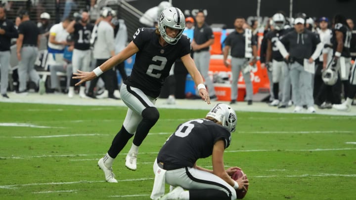 Sep 18, 2022; Paradise, Nevada, USA; Las Vegas Raiders place kicker Daniel Carlson (2) kicks a field goal out of the hold of punter AJ Cole (6) in the first half against the Arizona Cardinals at Allegiant Stadium. Mandatory Credit: Kirby Lee-USA TODAY Sports