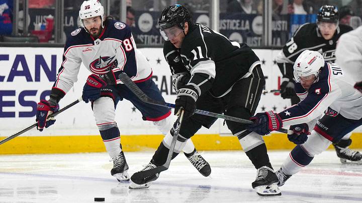 Feb 20, 2024; Los Angeles, California, USA; LA Kings center Anze Kopitar (11) battles for the puck with Columbus Blue Jackets right wing Kirill Marchenko (86) and center Cole Sillinger (4) in the second period at Crypto.com Arena. Mandatory Credit: Kirby Lee-USA TODAY Sports