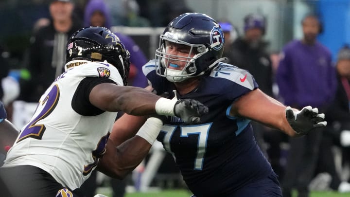 Oct 15, 2023; London, United Kingdom; Tennessee Titans offensive tackle Peter Skoronski (77) defends against Baltimore Ravens defensive tackle Justin Madubuike (92) in the second half during an NFL International Series game at Tottenham Hotspur Stadium. Mandatory Credit: Kirby Lee-USA TODAY Sports