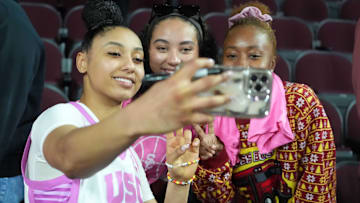USC Trojans guard JuJu Watkins poses for a selfie with fans after a game against the Michigan State Spartans.