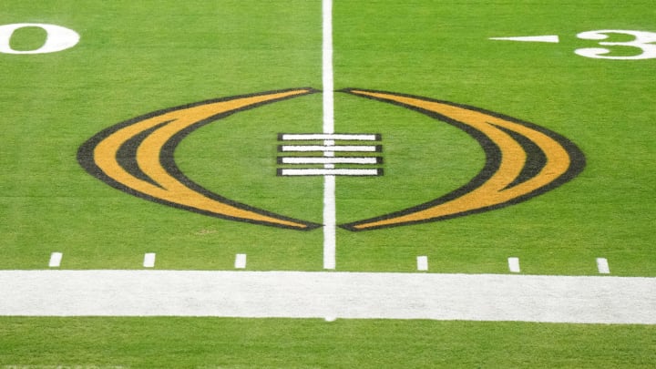 The College Football Playoff logo on the field at State Farm Stadium. 