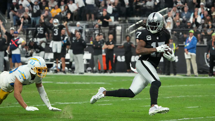 Dec 4, 2022; Paradise, Nevada, USA; Las Vegas Raiders wide receiver Davante Adams (17) scores on a 45-yard touchdown reception against Los Angeles Chargers cornerback Bryce Callahan (23) n the second half at Allegiant Stadium. The Raiders defeated the Chargers 27-20. Mandatory Credit: Kirby Lee-Imagn Images