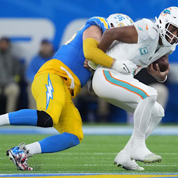 Dec 11, 2022; Inglewood, California, USA; Los Angeles Chargers defensive end Morgan Fox (56) sacks Miami Dolphins quarterback Tua Tagovailoa (1)
