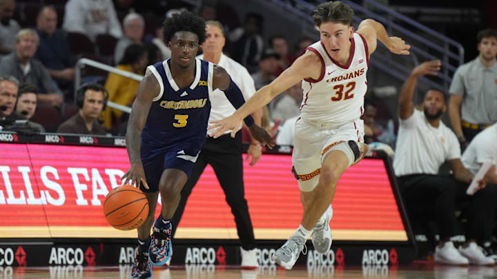 Nov 4, 2024; Los Angeles, California, USA; Chattanooga Mocs guard Honor Huff (3) dribbles the ball against Southern California Trojans guard Clark Slajchert (32) in the second half at Galen Center. Mandatory Credit: Kirby Lee-Imagn Images