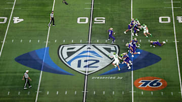 Dec 1, 2023; Las Vegas, NV, USA; A general overall view as Washington Huskies quarterback Michael Penix Jr. (9)] throws the ball at midfield on the Pac-12 Conference logo against the Oregon Ducks in the first half at Allegiant Stadium. Mandatory Credit: Kirby Lee-Imagn Images