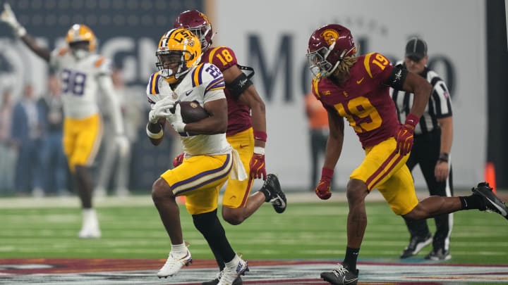 Sep 1, 2024; Paradise, Nevada, USA;  LSU Tigers running back John Emery Jr. (22) carries the ball against  Southern California Trojans cornerback John Humphrey (19) in the second half at Allegiant Stadium. Mandatory Credit: Kirby Lee-USA TODAY Sports