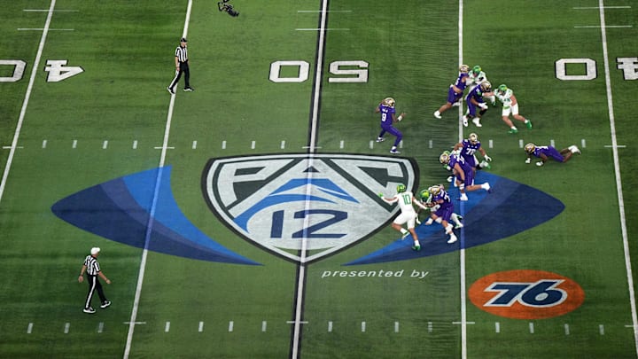 Dec 1, 2023; Las Vegas, NV, USA; A general overall view as Washington Huskies quarterback Michael Penix Jr. (9)] throws the ball at midfield on the Pac-12 Conference logo against the Oregon Ducks in the first half at Allegiant Stadium. Mandatory Credit: Kirby Lee-Imagn Images
