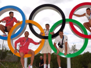 Members of the German volleyball team pose with the Olympic rings at the 2024 Paris Olympics athlete village