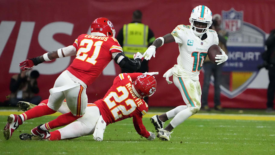 Miami Dolphins wide receiver Tyreek Hill (10) carries the ball against Kansas City Chiefs safety Mike Edwards (21) and cornerback Trent McDuffie (22) in the second half during an NFL International Series game at Deutsche Bank Park in 2023. | Kirby Lee-Imagn Images
