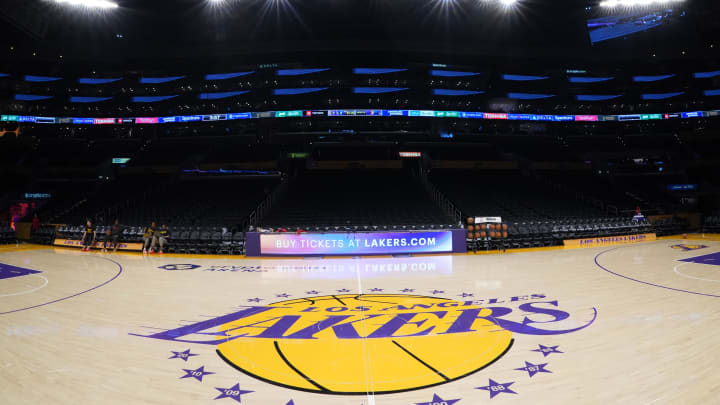 Apr 9, 2024; Los Angeles, California, USA; The Los Angeles Lakers logo at midcourt Crypto.com Arena. Mandatory Credit: Kirby Lee-USA TODAY Sports