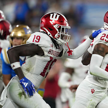 Indiana Hoosiers defensive backs Amare Ferrell (25) and Josh Sanguinetti (19) celebrate an interception against UCLA at the Rose owl.