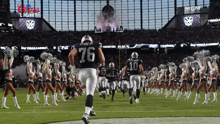 Aug 23, 2024; Paradise, Nevada, USA; Las Vegas Raiders defensive end Ron Stone Jr. (76) and quarterback Nathan Peterman (10) enter the field before the game against the San Francisco 49ers at Allegiant Stadium. Mandatory Credit: Kirby Lee-USA TODAY Sports