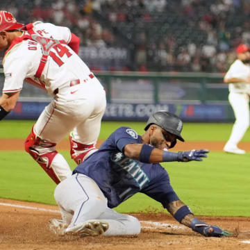 Seattle Mariners right fielder Victor Robles slides safe at home during a game against the Los Angeles Angels on Saturday at Angel Stadium.