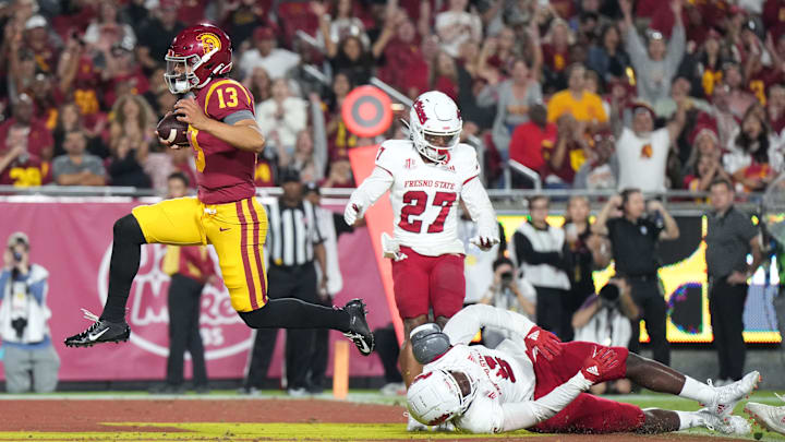 Sep 17, 2022; Los Angeles, California, USA; Southern California Trojans quarterback Caleb Williams (13) rushes for a touchdown against the Fresno State Bulldogs in the first half at United Airlines Field at Los Angeles Memorial Coliseum. Mandatory Credit: Kirby Lee-Imagn Images