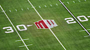 The Mountain West conference logo on the field at Allegiant Stadium. Mandatory Credit: Kirby Lee-Imagn Images