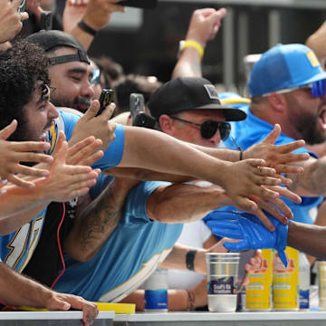 Sep 8, 2024; Inglewood, California, USA; 
Los Angeles Chargers running back J.K. Dobbins (27) celebrates with fans after scoring on a 12-yard touchdown run against the Las Vegas Raiders in the second half at SoFi Stadium. Mandatory Credit: Kirby Lee-Imagn Images