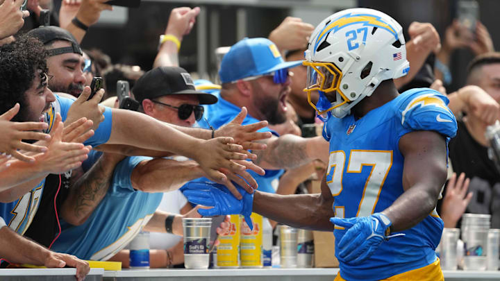 Sep 8, 2024; Inglewood, California, USA; 
Los Angeles Chargers running back J.K. Dobbins (27) celebrates with fans after scoring on a 12-yard touchdown run against the Las Vegas Raiders in the second half at SoFi Stadium. Mandatory Credit: Kirby Lee-Imagn Images