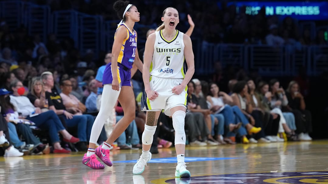 Aug 20, 2025; Los Angeles, California, USA; Dallas Wings guard Paige Bueckers (5) celebrates in the second half as LA Sparks guard Rae Burrell (12) watches at Crypto.com Arena. Mandatory Credit: Kirby Lee-Imagn Images