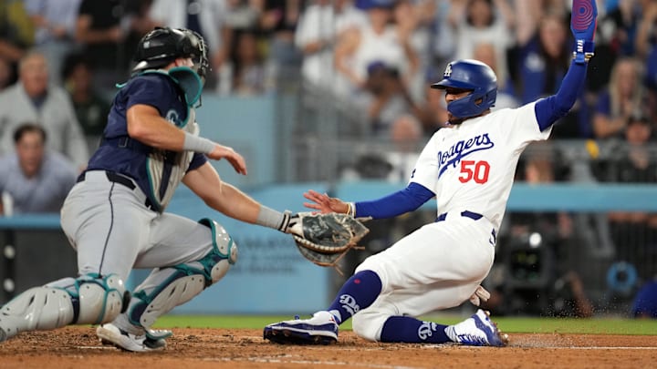 Seattle Mariners catcher Cal Raleigh tags out a runner during a game against the Los Angeles Dodgers on Aug. 20 at Dodger Stadium.