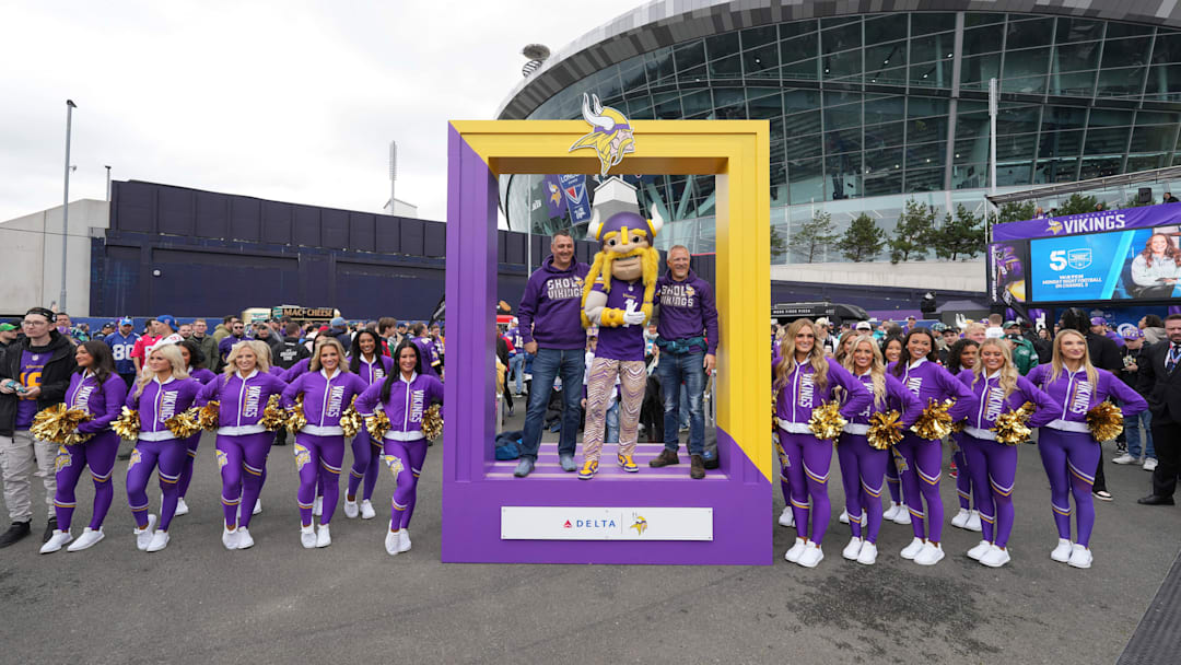 Minnesota Vikings fans pose with mascot Viktor and cheerleaders before a game at Tottenham Hotspur Stadium in London on Oct. 6, 2024.