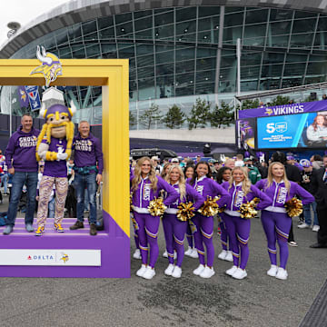 Minnesota Vikings fans pose with mascot Viktor and cheerleaders before a game at Tottenham Hotspur Stadium in London on Oct. 6, 2024.