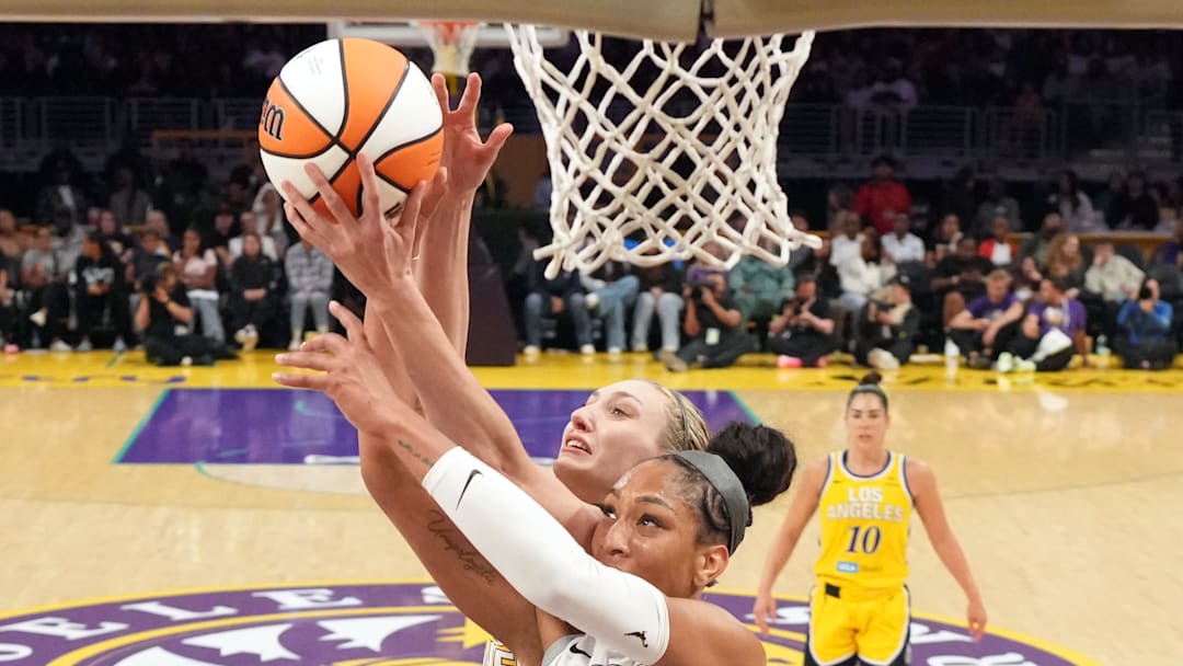 Jul 29, 2025; Los Angeles, California, USA; LA Sparks forward Cameron Brink (back) and Las Vegas Aces center A'ja Wilson (front) battle for the ball at the Crypto.com Arena. 