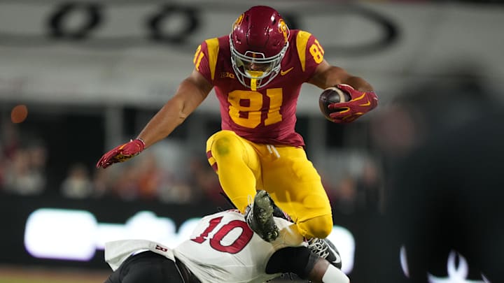 Oct 25, 2024; Los Angeles, California, USA; Southern California Trojans wide receiver Kyle Ford (81) hurdles Rutgers Scarlet Knights defensive back Flip Dixon (10) in the first half at United Airlines Field at Los Angeles Memorial Coliseum. Mandatory Credit: Kirby Lee-Imagn Images