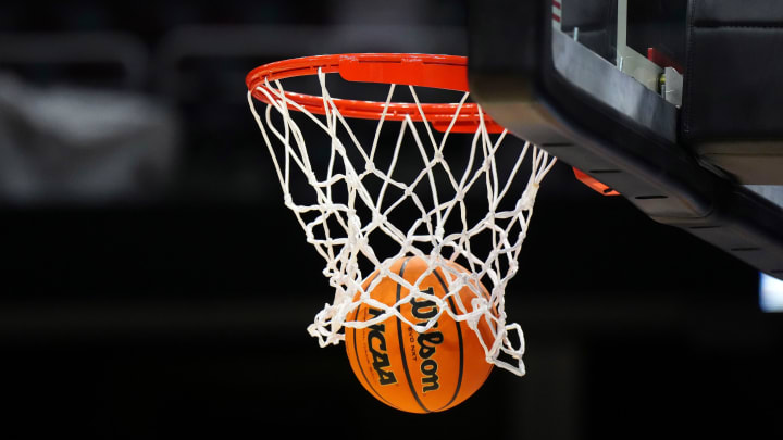 Apr 4, 2024; Cleveland, OH, USA; A Wilson official Evo NXT basketball with the NCAA Women's Final Four March Madness logo approaches the rim and net at Rocket Mortgage FieldHouse. Mandatory Credit: Kirby Lee-USA TODAY Sports