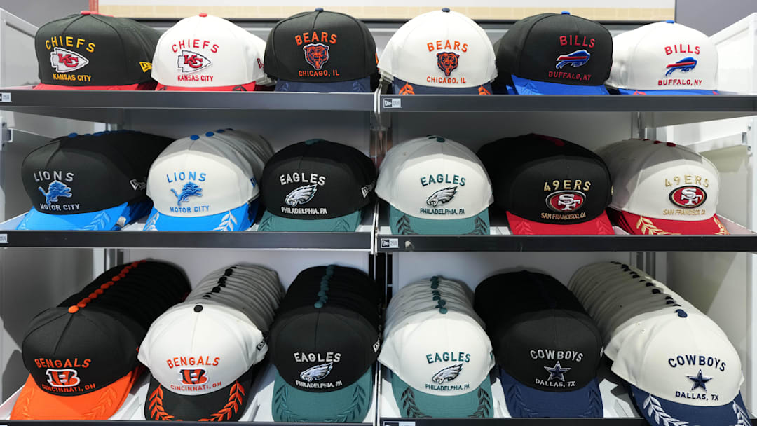 Apr 23, 2025; Green Bay, WI, USA; New Era NFL Draft hats of the Kansas City Chiefs, Chicago Bears, Buffalo BIlls, Detroit Lions, Philadelphia Eagles, San Francisco 49ers, Cincinnati Bengals and Dallas Cowboys at the NFL Draft Experience at Lambeau Field. Mandatory Credit: Kirby Lee-Imagn Images