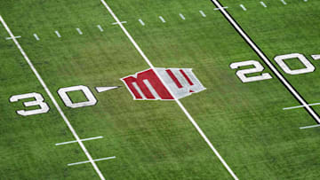 The Mountain West conference logo on the field at Allegiant Stadium. Mandatory Credit: Kirby Lee-Imagn Images