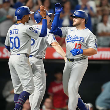 Aug 11, 2025; Anaheim, California, USA; Los Angeles Dodgers third baseman Max Muncy (13) celebrates with shortstop Mookie Betts (50) after hitting a three-run home run in the eighth inning against the Los Angeles Angels at Angel Stadium. Mandatory Credit: Kirby Lee-Imagn Images