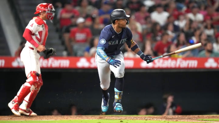 Seattle Mariners center fielder Julio Rodriguez hits a two-run single against the Los Angeles Angels on Saturday at Angel Stadium.