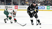 Apr 15, 2024; Los Angeles, California, USA; LA Kings defenseman Drew Doughty (8) and Minnesota Wild center Marco Rossi (23) battle for the puck in the second period at Crypto.com Arena. Mandatory Credit: Kirby Lee-Imagn Images